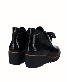Black embossed leather wedge ankle boots